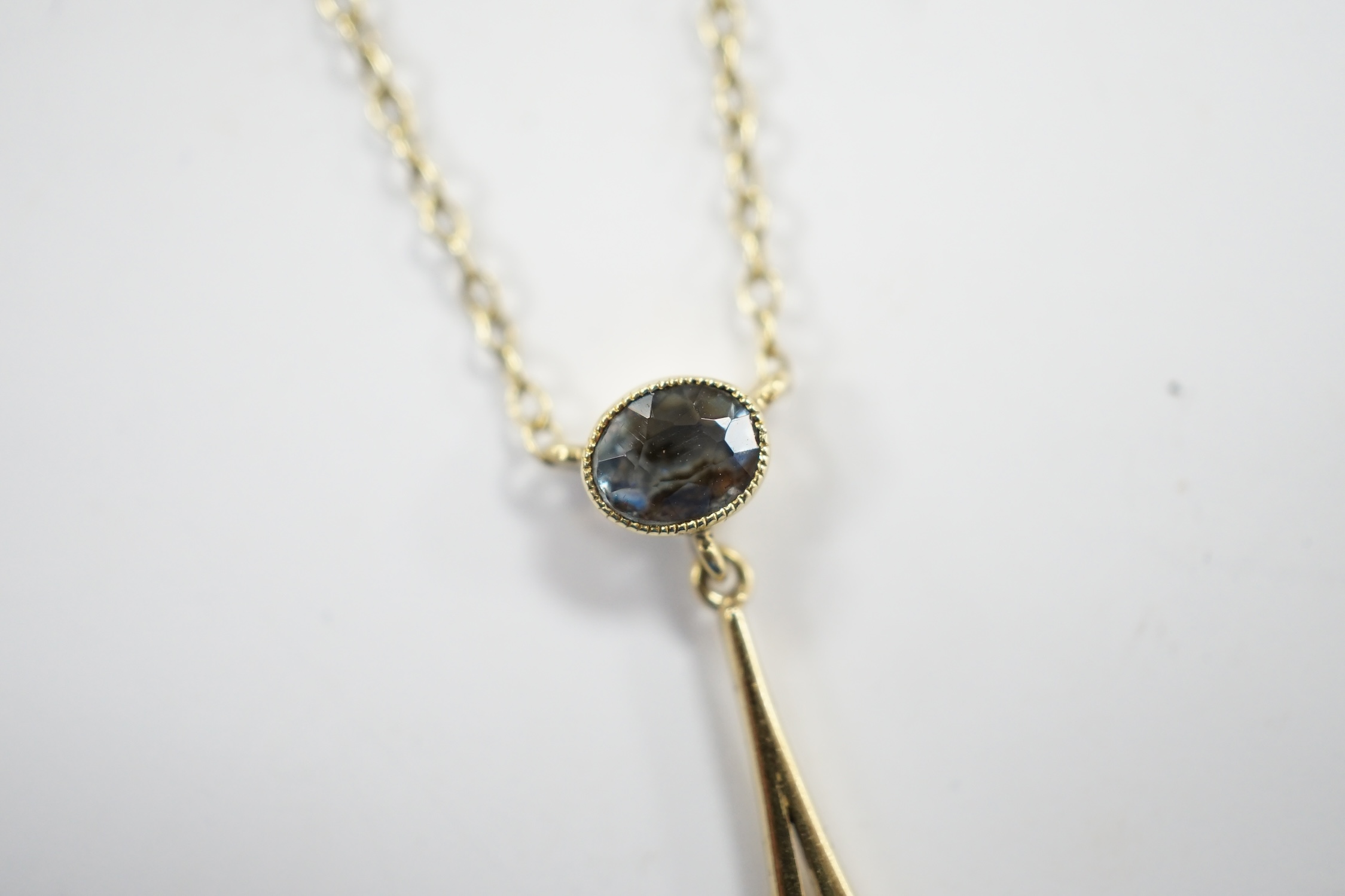 An Edwardian Art Nouveau 15ct and two stone aquamarine set drop pendant necklace, overall 43cm, gross weight 2.9 grams.